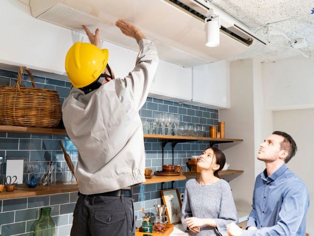 Technician performing preventive HVAC maintenance and inspection